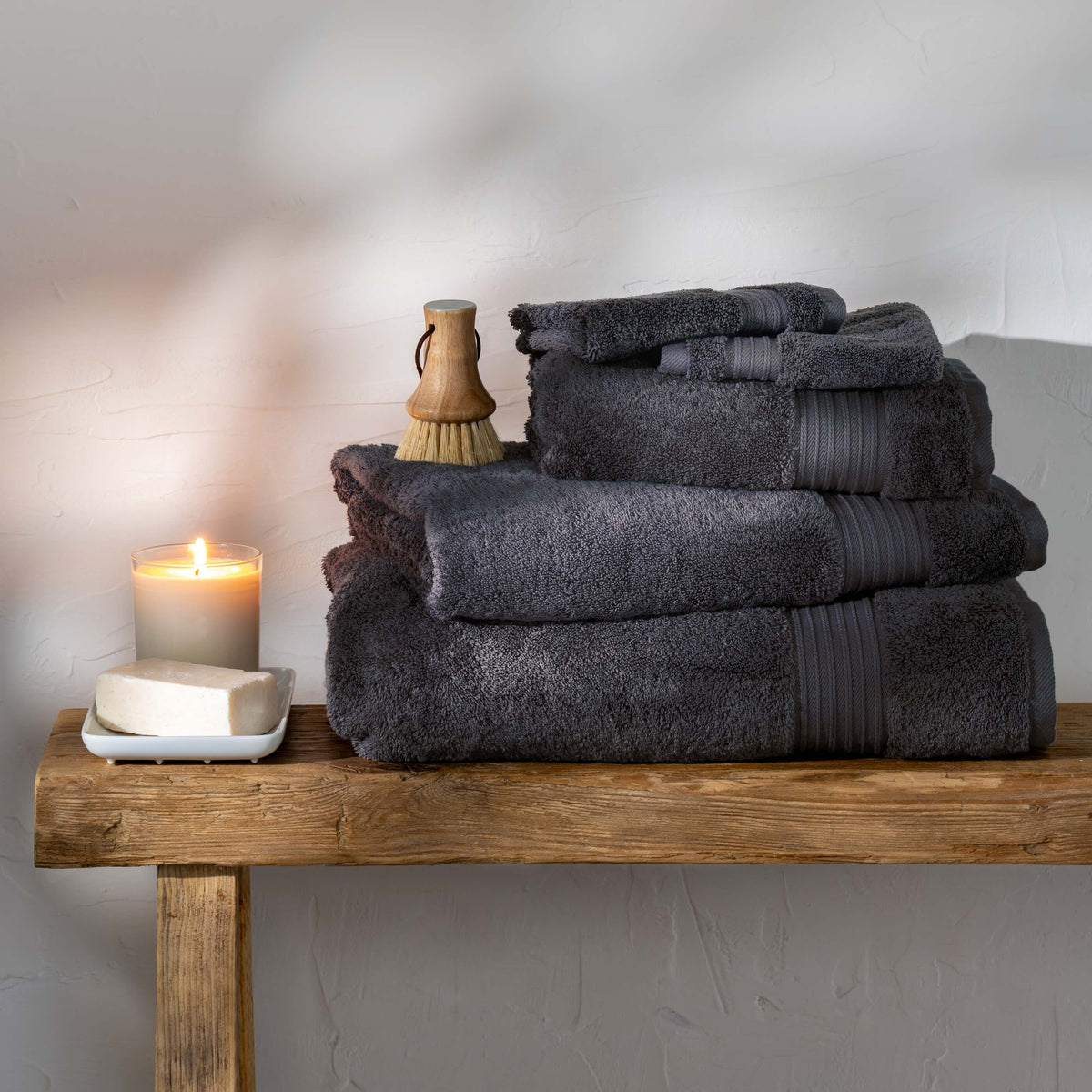 Smoke Egyptian Cotton Towels styled in a bedroom | Soak and Sleep