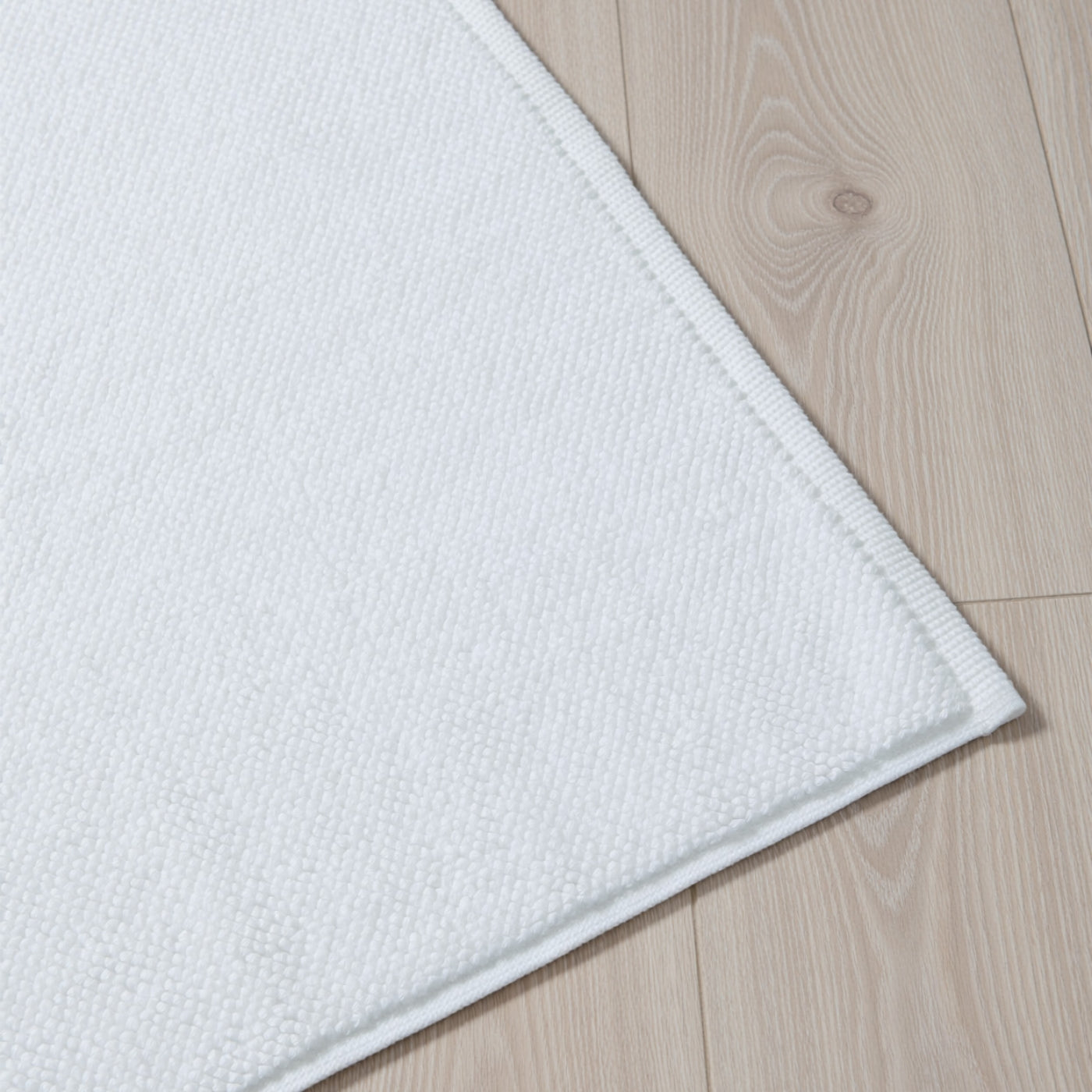 White Textured Cotton Bath Mat styled in a bedroom 1 | Soak and Sleep