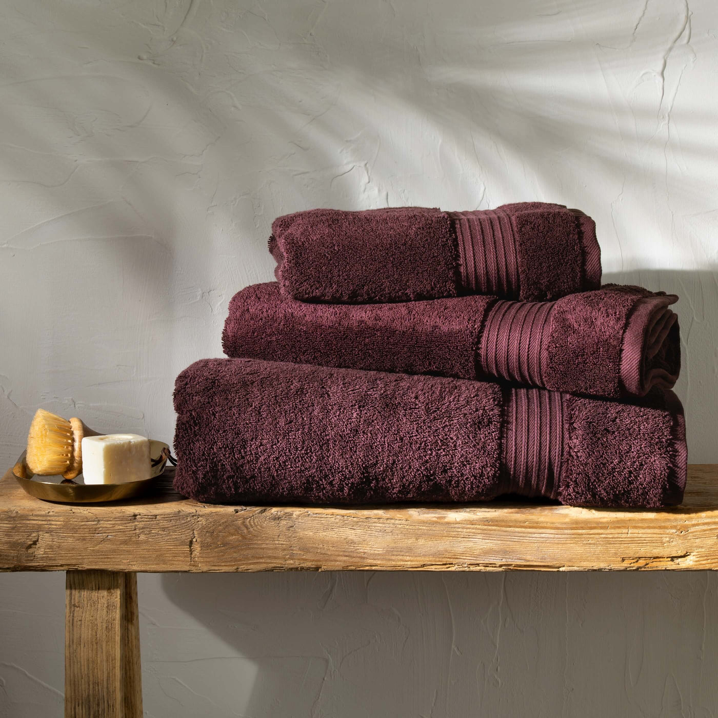 Aubergine Egyptian Cotton Towel Bale styled in a bedroom | Soak and Sleep
