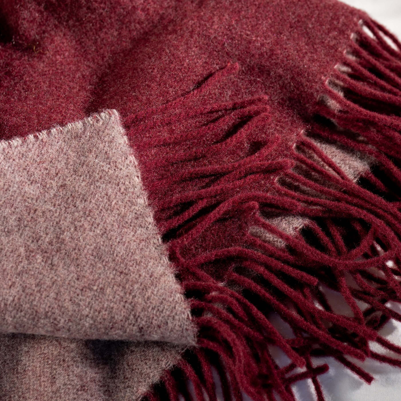 Bordeaux Luxury Wool with Cashmere Throw styled in a bedroom | Soak and Sleep