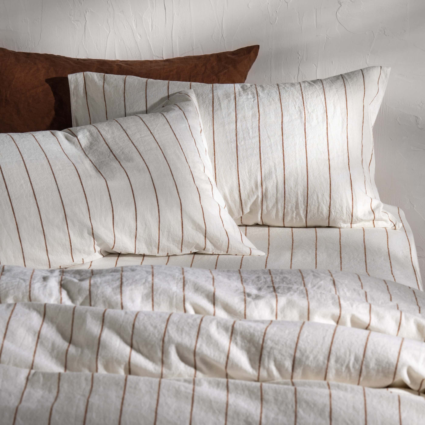 White/Burnt Orange Pinstripe Linen/Cotton Duvet Cover styled in a bedroom | Soak and Sleep