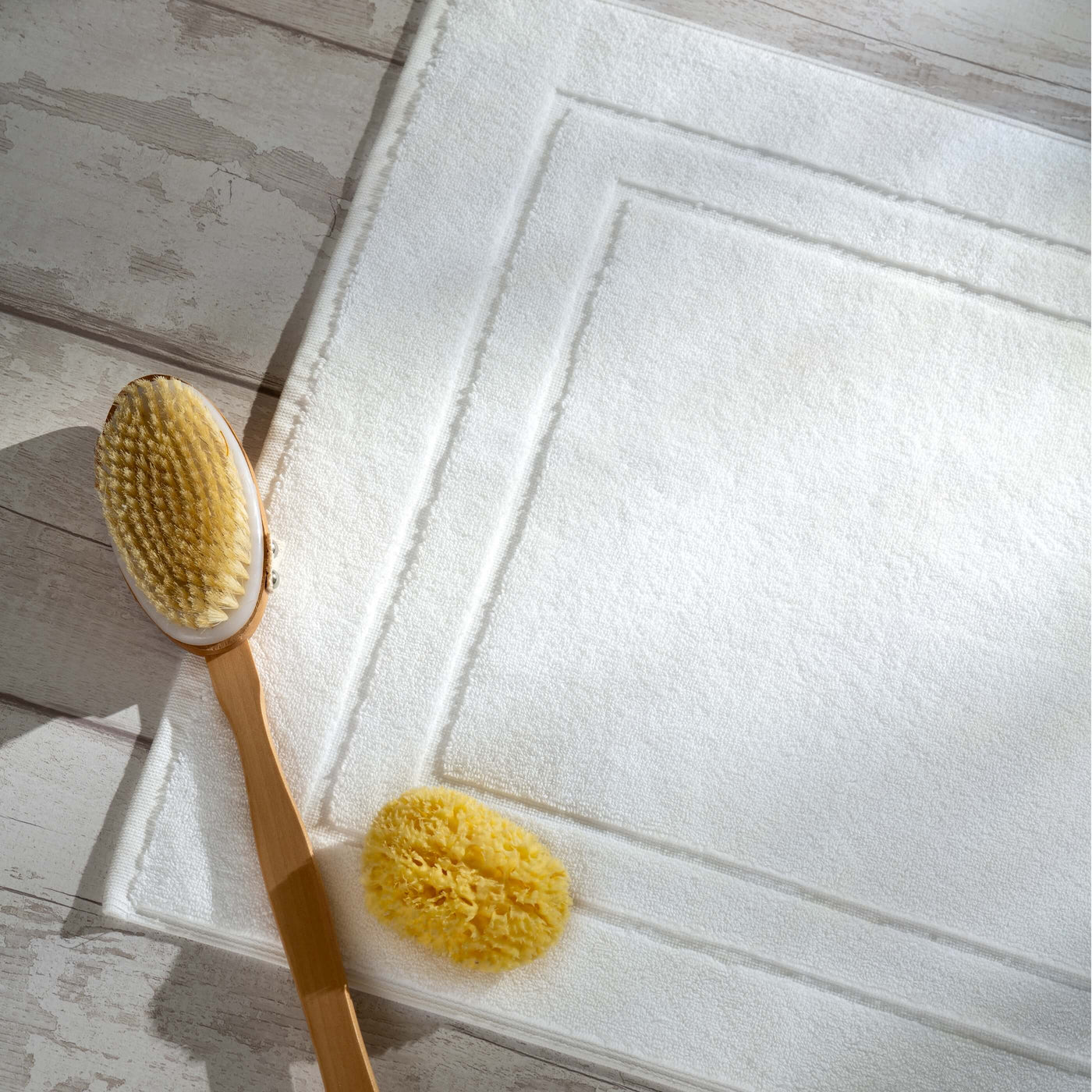 White Egyptian Cotton Bath Mat styled in a bedroom | Soak and Sleep
