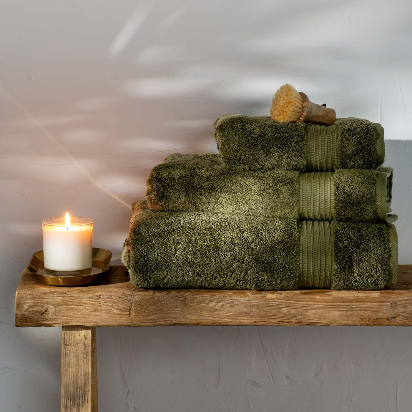 Olive Green Egyptian Cotton Towels styled in a bedroom | Soak and Sleep