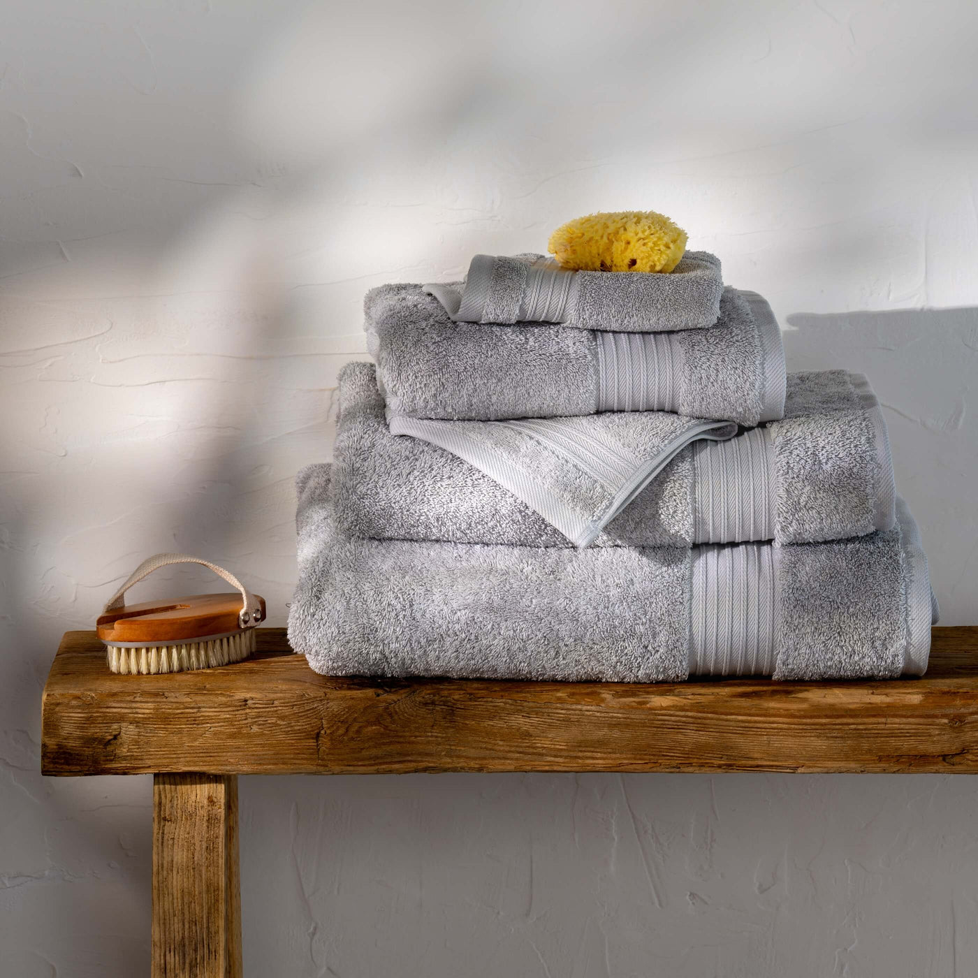 Light Grey Egyptian Cotton Towels styled in a bedroom | Soak and Sleep