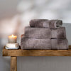 Mid Grey Egyptian Cotton Towels styled in a bedroom | Soak and Sleep