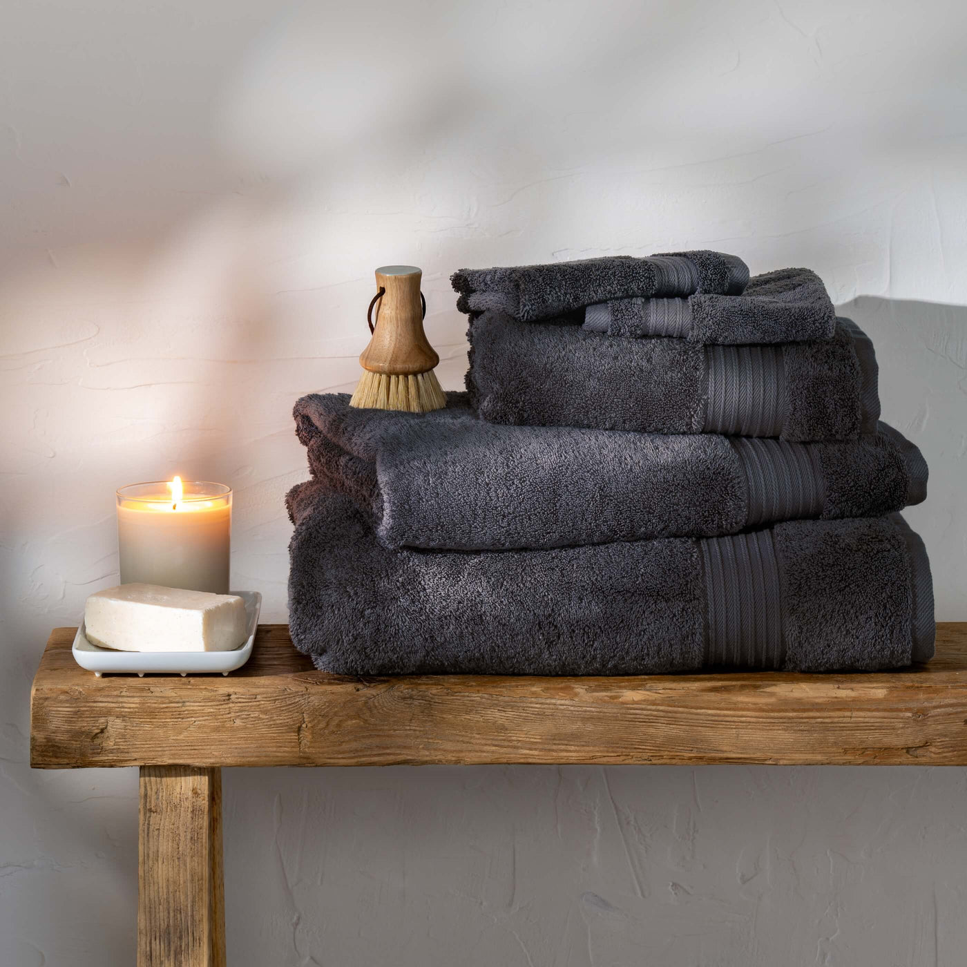 Smoke Egyptian Cotton Towels styled in a bedroom | Soak and Sleep