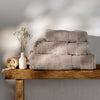 Taupe Egyptian Cotton Towels styled in a bedroom | Soak and Sleep
