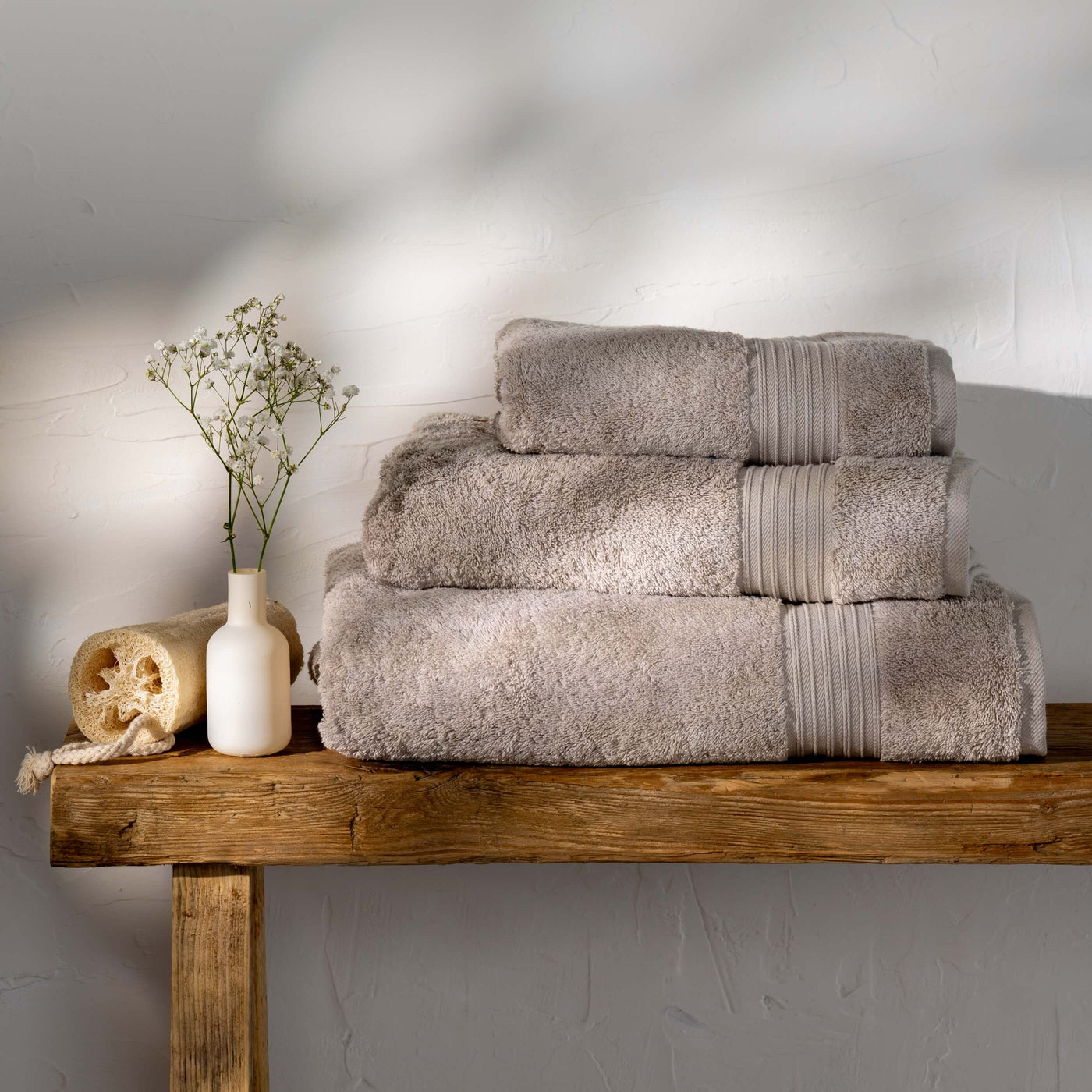 Taupe Egyptian Cotton Towels styled in a bedroom | Soak and Sleep