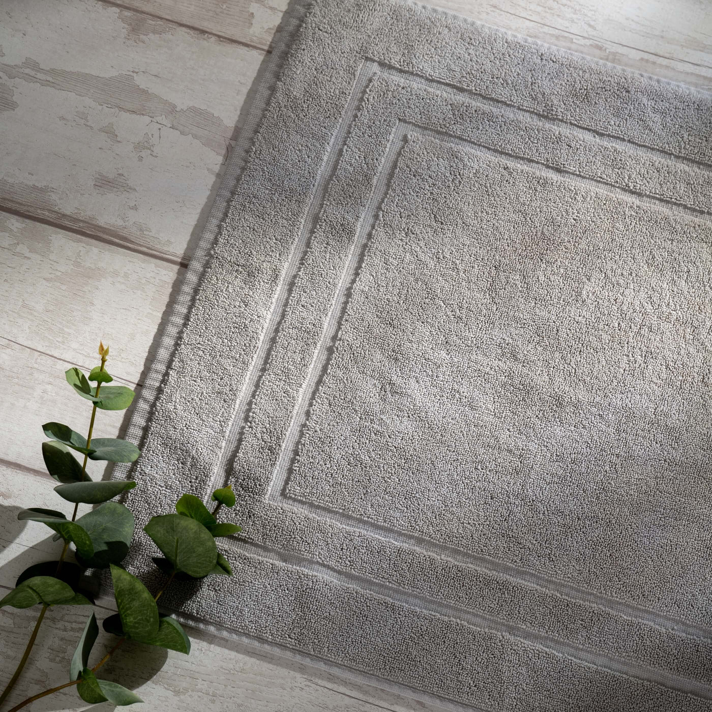 Light Grey Egyptian Cotton Bath Mat styled in a bedroom | Soak and Sleep