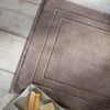 Mid Grey Egyptian Cotton Bath Mat styled in a bedroom | Soak and Sleep