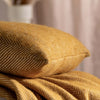Mustard Herringbone Pure Wool Cushion styled in a bedroom 1 | Soak and Sleep