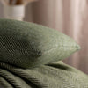 Olive Green Herringbone Pure Wool Cushion styled in a bedroom | Soak and Sleep