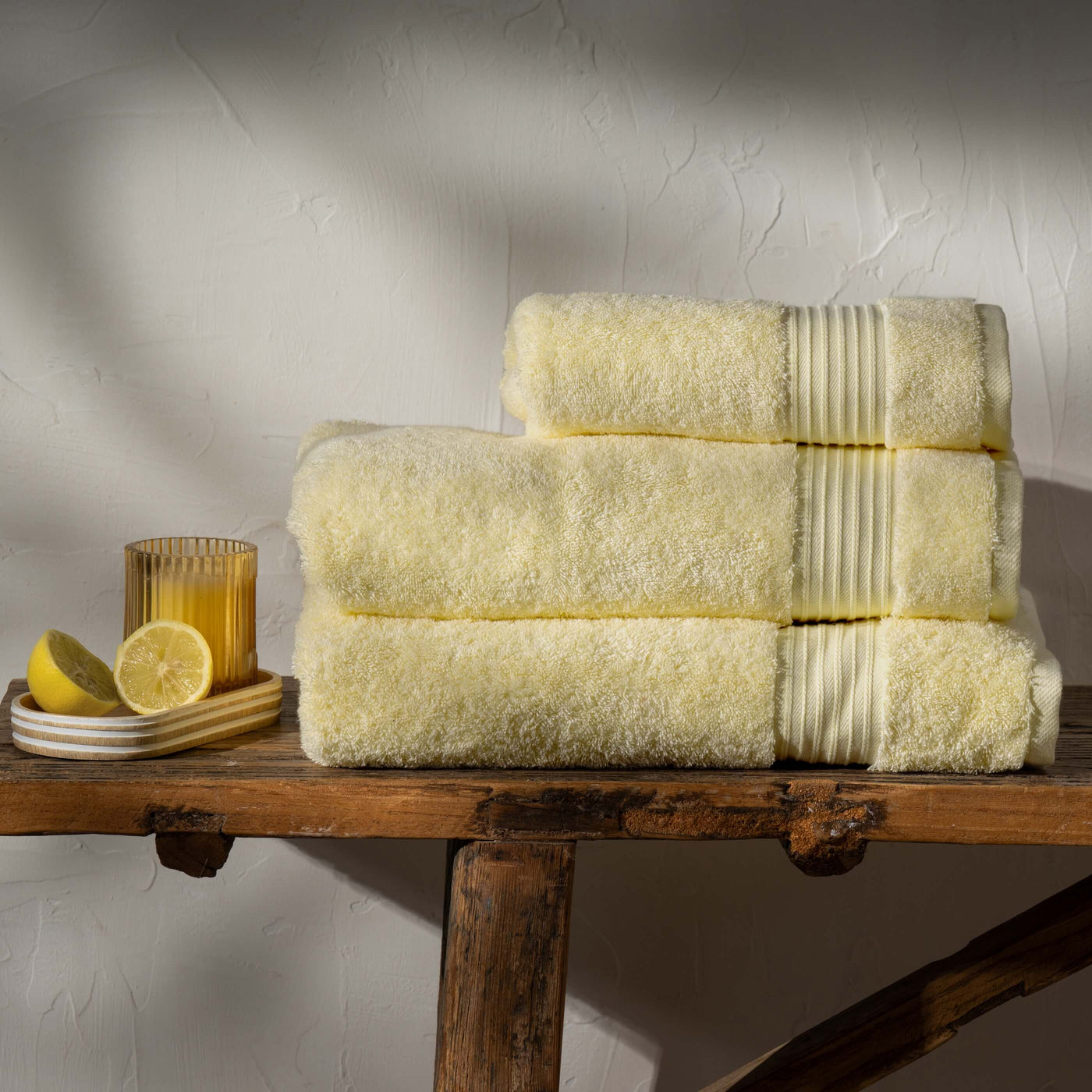 Lemon Yellow  Egyptian Cotton Towels styled in a bedroom | Soak and Sleep