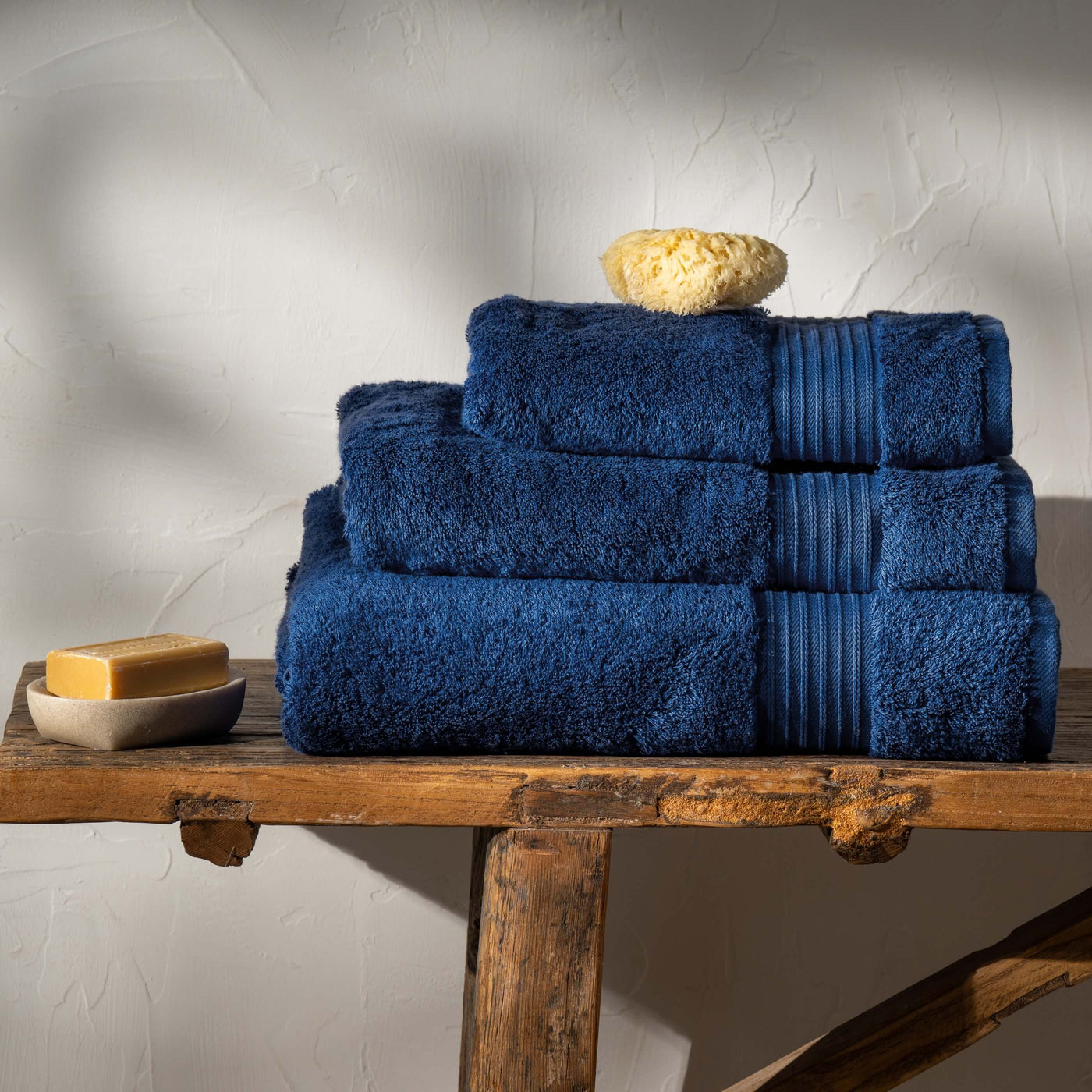 Mediterranean Blue Egyptian Cotton Towels styled in a bedroom | Soak and Sleep
