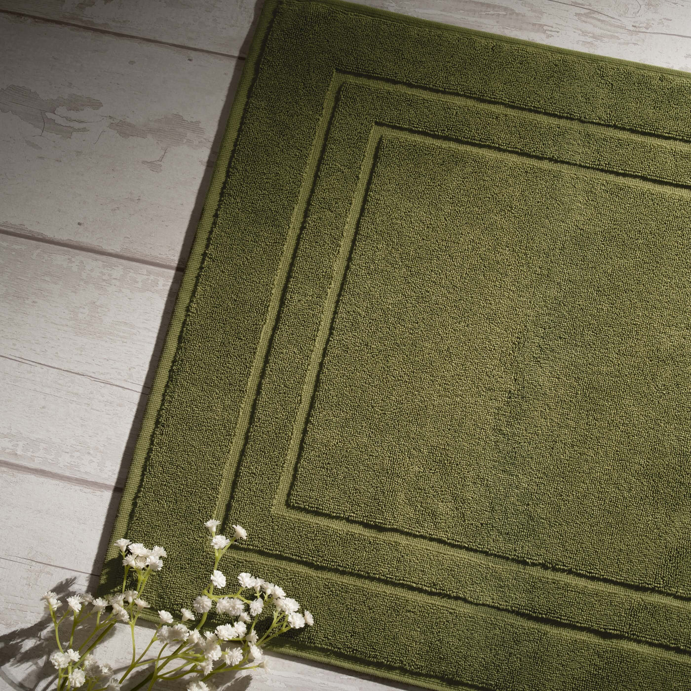 Olive Green Egyptian Cotton Bath Mat styled in a bedroom | Soak and Sleep