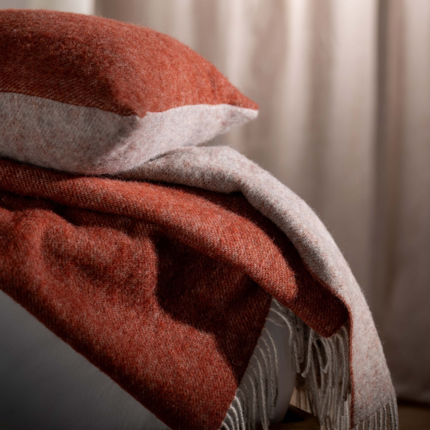 Burnt Orange Reversible Pure Wool Cushions & Throws - mustard, herringbone, styled in a bedroom | Soak and Sleep