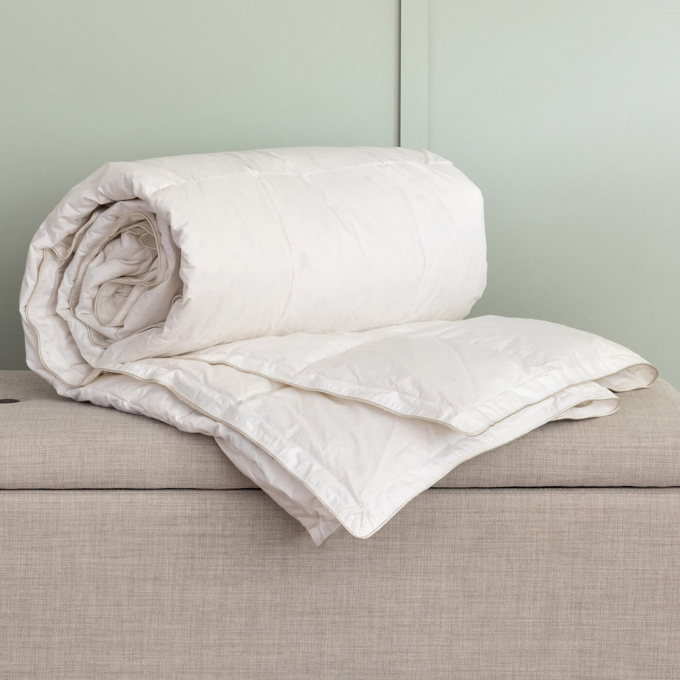 Hungarian Goose Down Duvet by Soak&Sleep, rolled and styled to show the detailing of the fabric. 