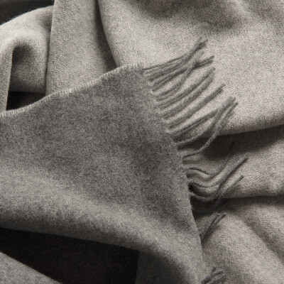 Close up of luxury Wool with Cashmere throw by Soak&Sleep in a light grey