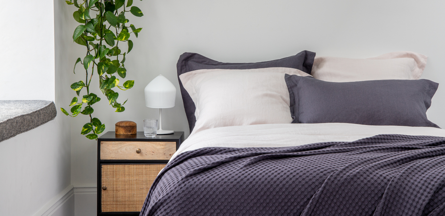 Soak&Sleep French Linen with Waffle Cotton Throw, styled with hanging plant and rattan bedside table