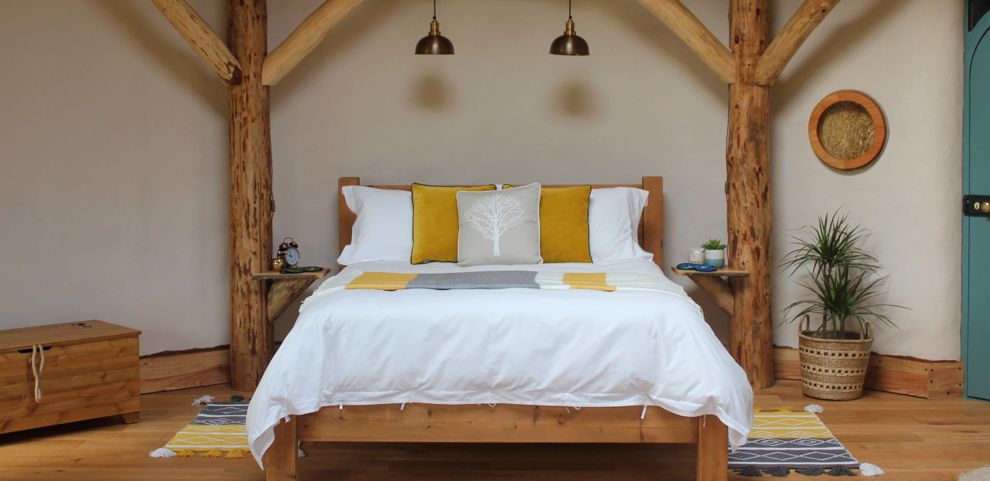 Soak&Sleep crisp white bedlinen with tie fastenings, decorated with mustard yellow cushions