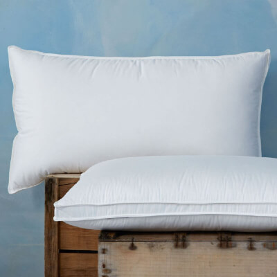 Two 100% Canadian Goose Down Pillows, displayed on a wooden crate