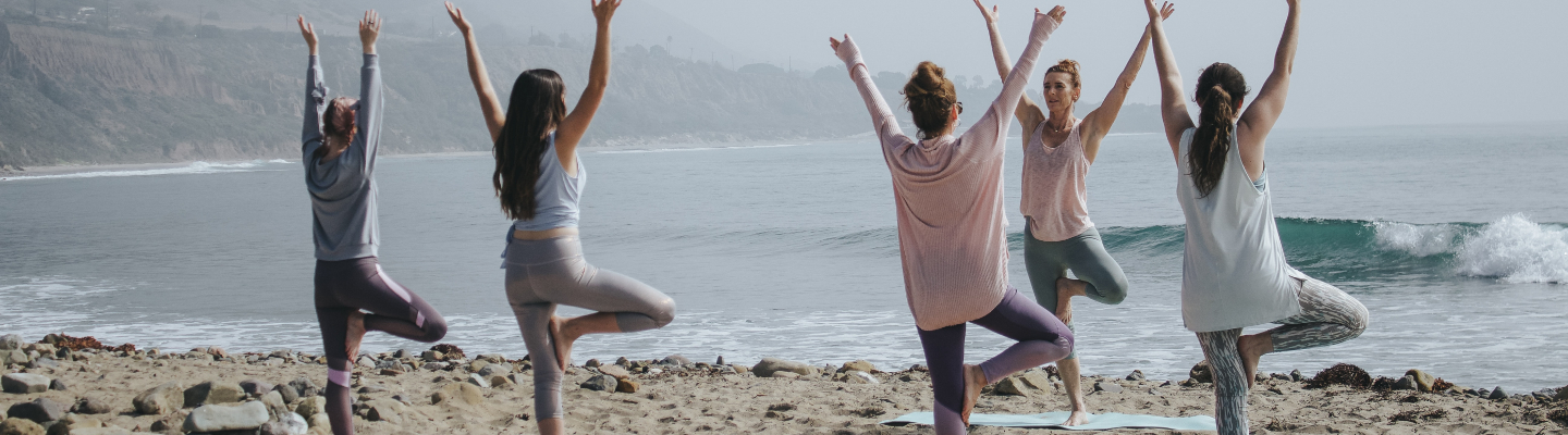 Group yoga on the beach