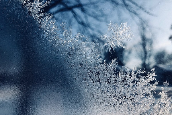 winter snowflakes creating frost on window